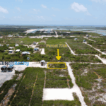 Aerial view of parcel 7746 highlighted with arrow showing exact lot location near road and lagoon in Ambergris Caye Belize