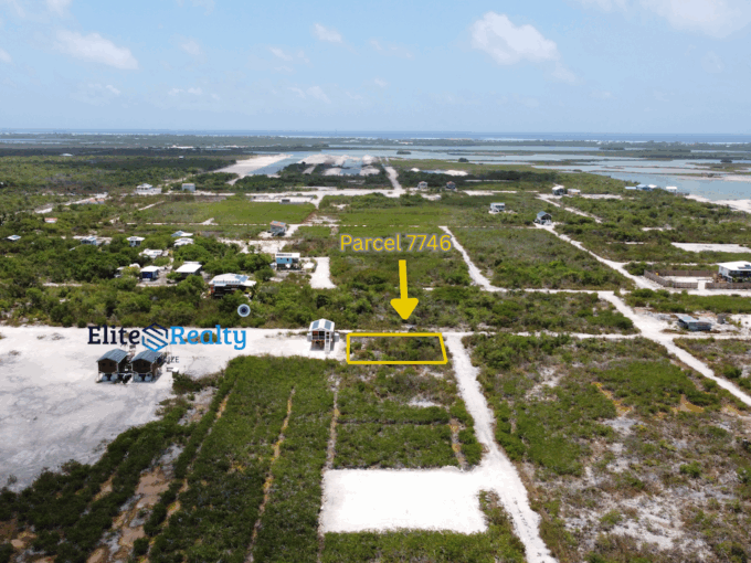 Aerial view of parcel 7746 highlighted with arrow showing exact lot location near road and lagoon in Ambergris Caye Belize