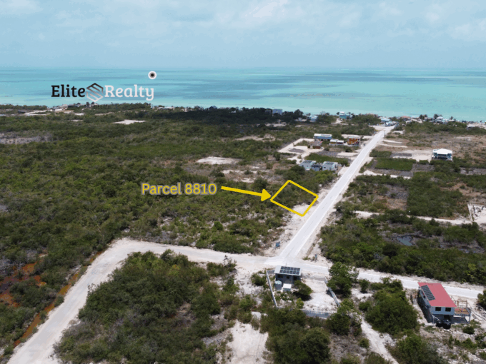 Aerial view showing highlighted lot along main road with ocean in the background near Secret Beach Ambergris Caye Belize