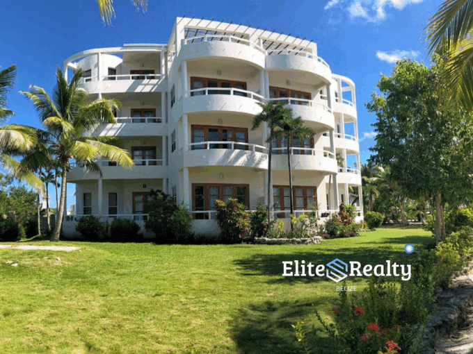 Condo building at Brahma Blue Resort with landscaped grounds and open green space in San Pedro Belize