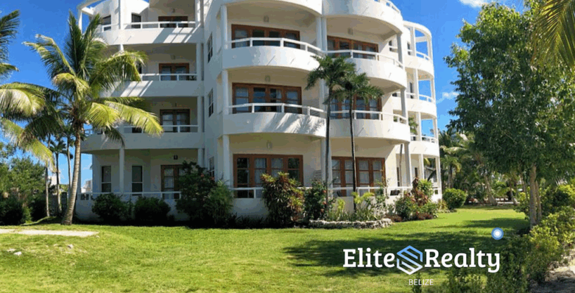 Condo building at Brahma Blue Resort with landscaped grounds and open green space in San Pedro Belize
