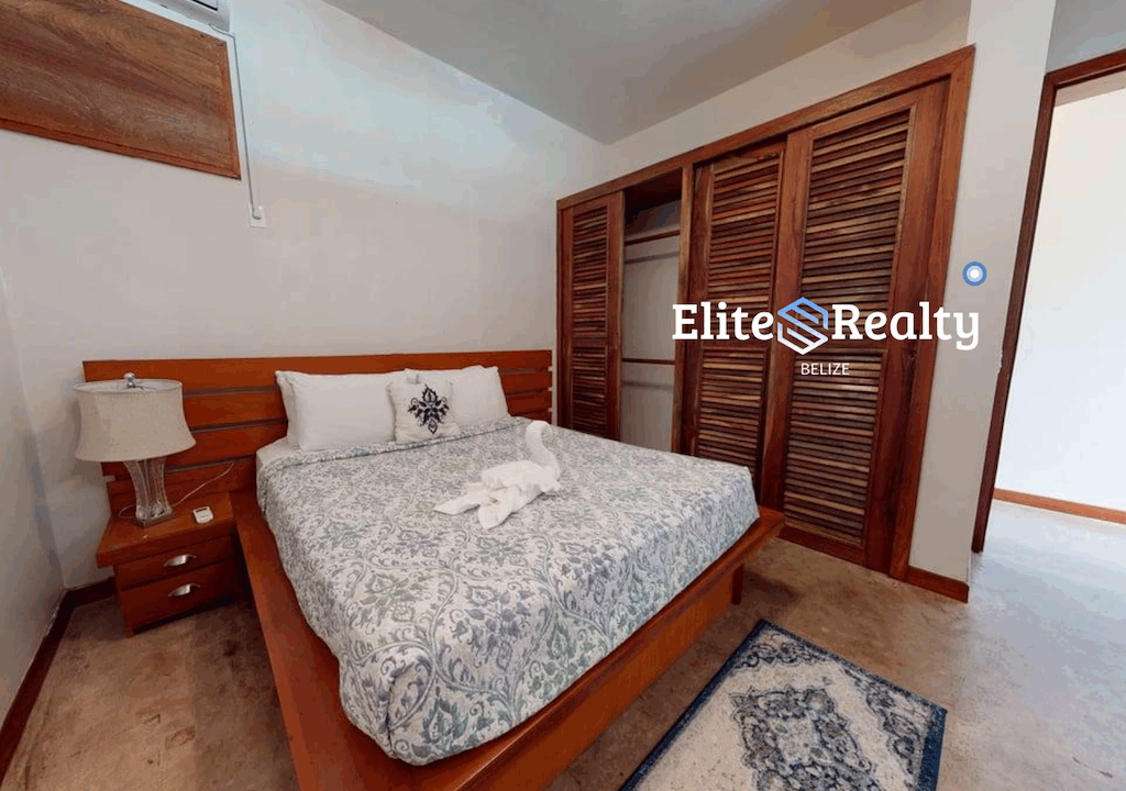 Guest Bedroom With Wood Bed Closet And Air Conditioning In Brahma Blue Resort Condo San Pedro Belize