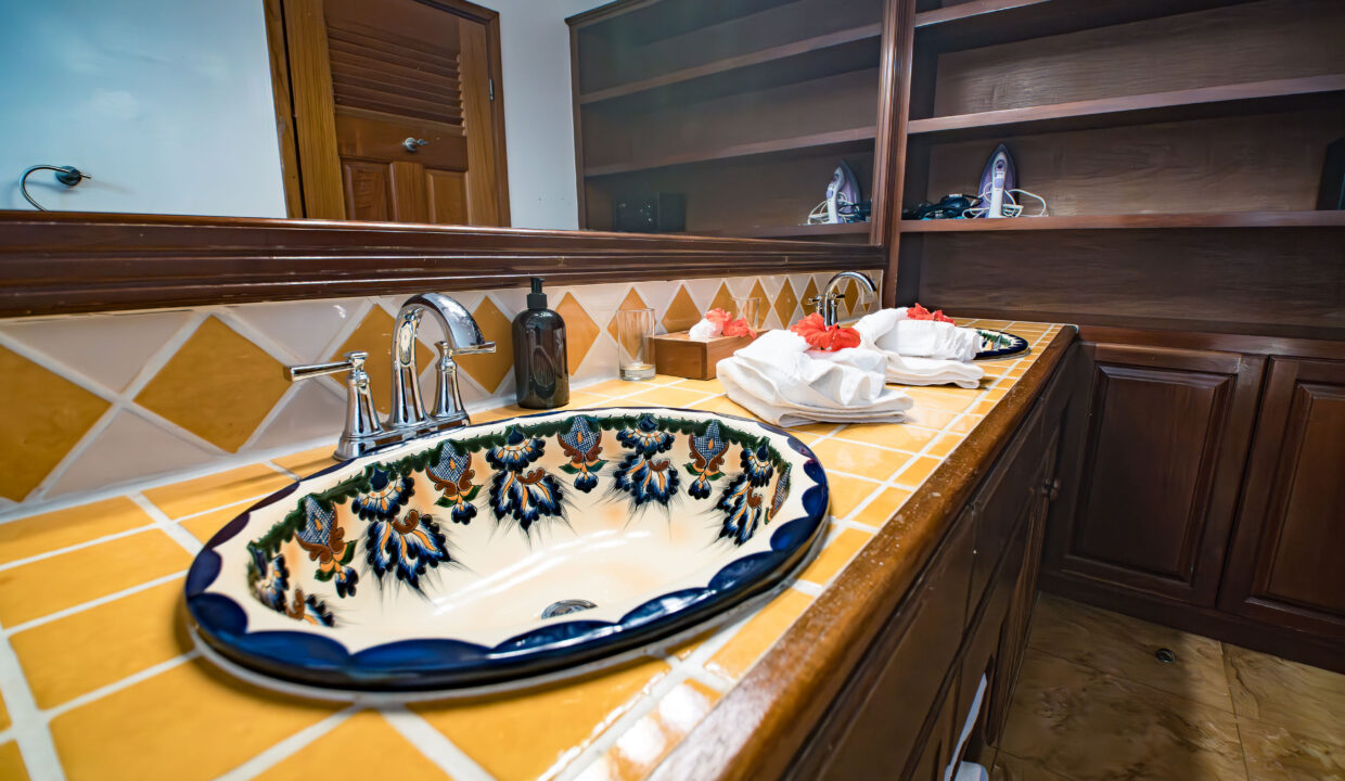 Custom Bathroom Vanity With Handcrafted Sink At Hopkins Bay Resort Belize Luxury Villa Interior With Wooden Cabinetry And Tile Countertop