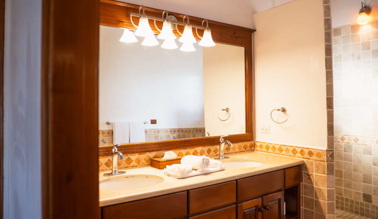 Double Vanity Bathroom With Walk In Shower At Hopkins Bay Resort Belize Luxury Caribbean Villa With Modern Lighting And Tile Finishes