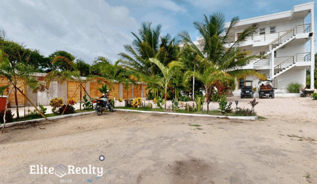 Exterior View Of Blue Water Beach Resort With Parking Area And Landscaped Grounds Belize