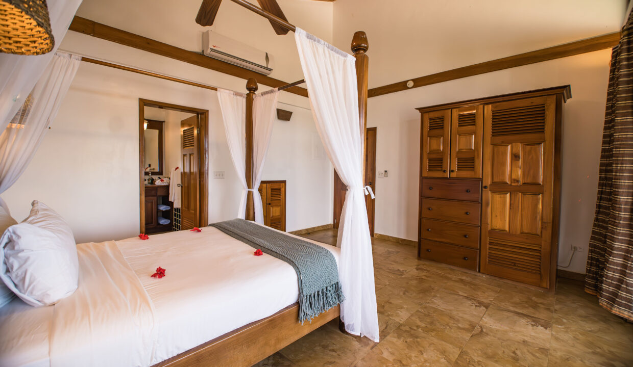 Master Bedroom With Built In Wooden Storage And Canopy Bed At Hopkins Bay Resort Belize Luxury Caribbean Villa Interior