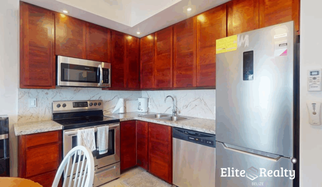 Modern Kitchen With Stainless Steel Appliances Wood Cabinets And Granite Countertops Blue Water Beach Resort Belize