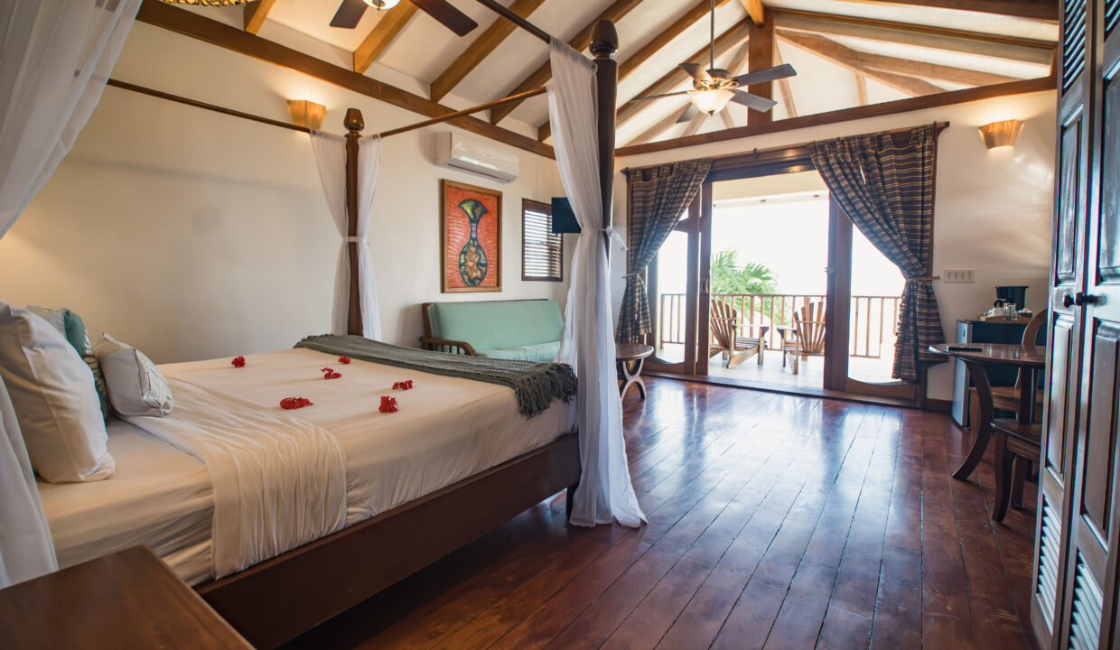 Spacious Beachfront Villa Bedroom With Balcony At Hopkins Bay Resort Belize Luxury Caribbean Interior With Wooden Floors And Ocean View