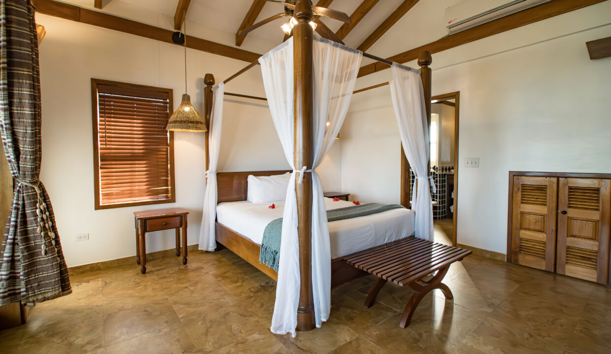 Spacious Master Suite At Hopkins Bay Resort Belize With Canopy Bed Wooden Finishes And Open Layout Luxury Villa Interior