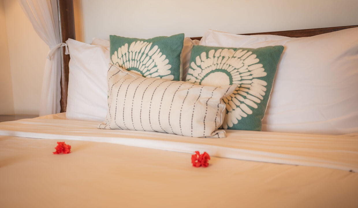 Stylish Bedroom Detail With Decorative Pillows And Linens At Hopkins Bay Resort Belize Luxury Caribbean Villa