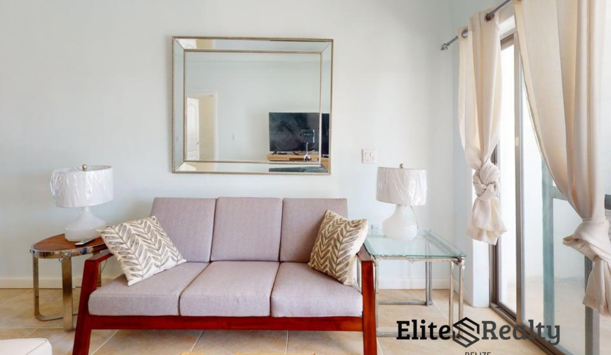 Bright Living Room With Sofa And Balcony Access In Beachfront Condo At Blue Water Beach Resort San Pedro Ambergris Caye Belize