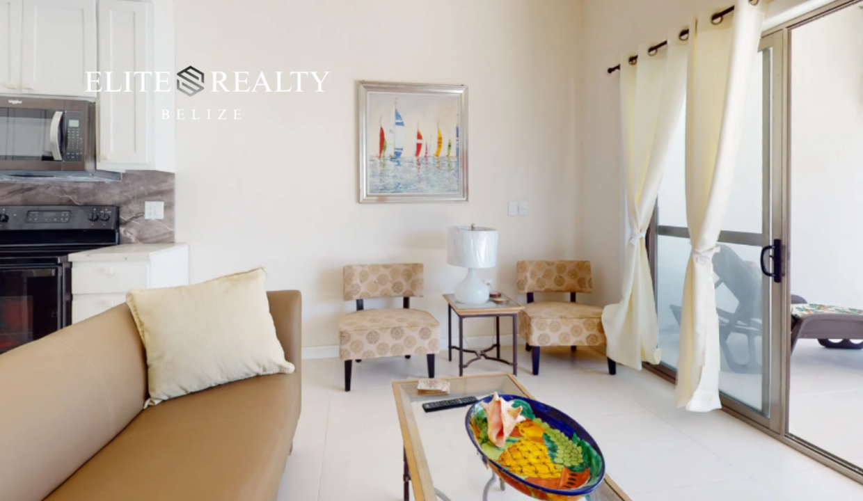 Living Area With Seating Coffee Table And Sliding Doors To Beachfront Patio At Blue Water Beach Resort Ambergris Caye Belize