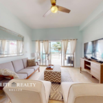 Living room with ocean view balcony inside beachfront condo at Blue Water Beach Resort San Pedro Ambergris Caye Belize