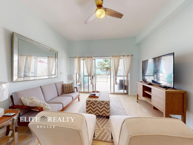 Living room with ocean view balcony inside beachfront condo at Blue Water Beach Resort San Pedro Ambergris Caye Belize
