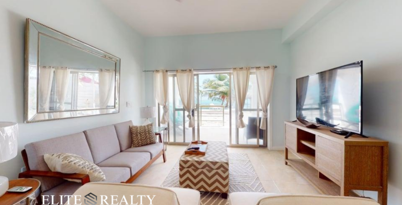 Living room with ocean view balcony inside beachfront condo at Blue Water Beach Resort San Pedro Ambergris Caye Belize