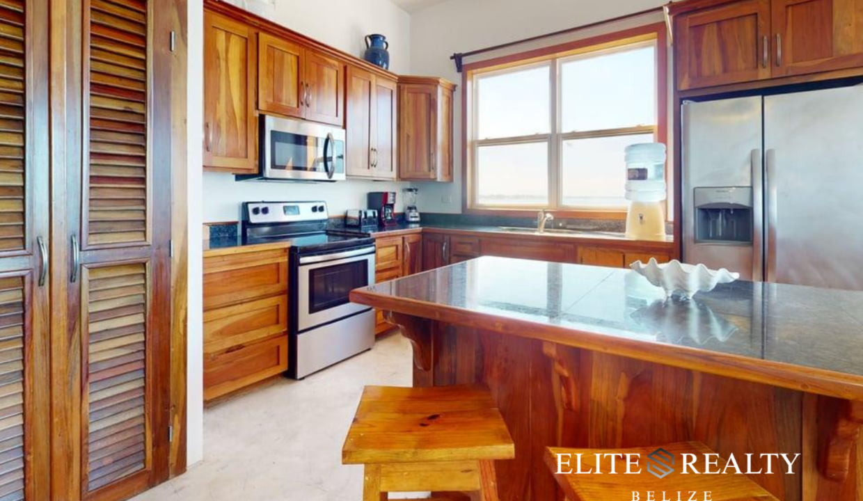 Luxury Kitchen With Island Seating At Brahma Blue Penthouse In San Pedro Ambergris Caye