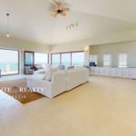 Spacious oceanfront living room with panoramic Caribbean Sea views in luxury penthouse Ambergris Caye Belize