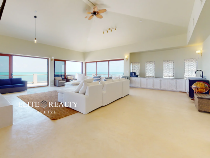 Spacious oceanfront living room with panoramic Caribbean Sea views in luxury penthouse Ambergris Caye Belize