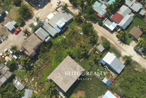 Aerial view of residential neighborhood with road access and nearby homes in Ambergris Caye Belize
