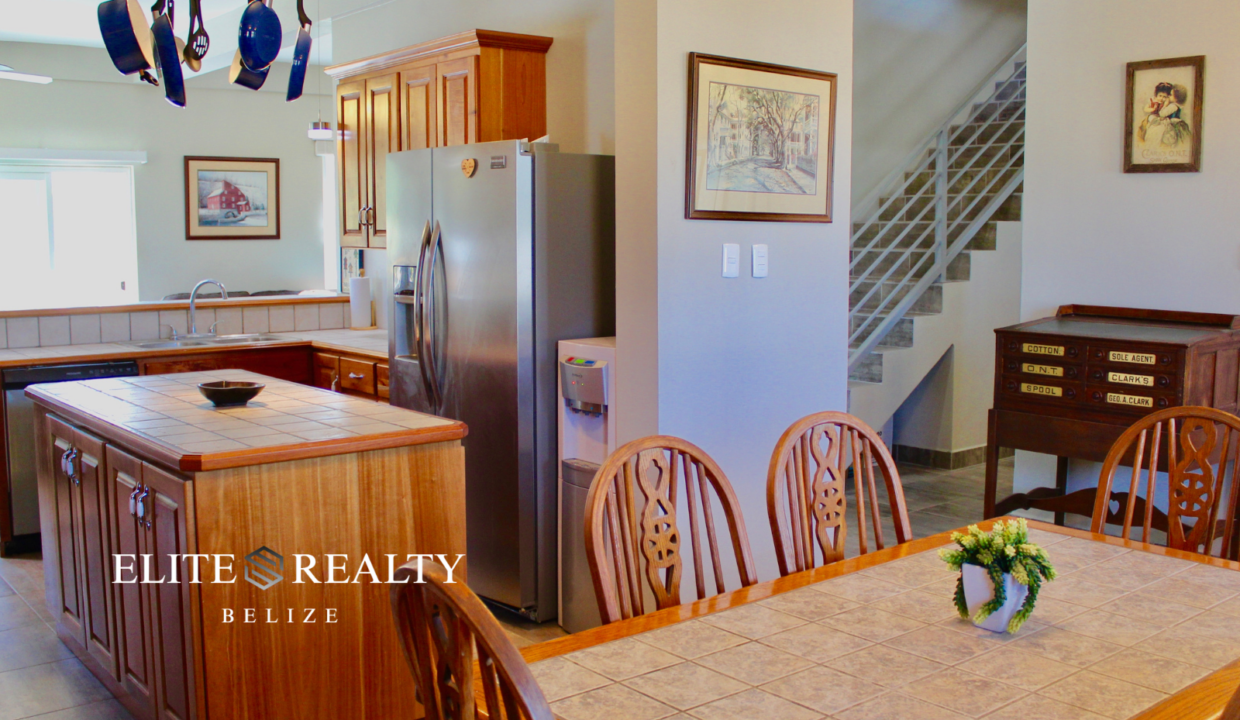 Kitchen Island And Dining Area With Hardwood Cabinetry In Waterfront Home At Tarpon Cove Estates Corozal Belize