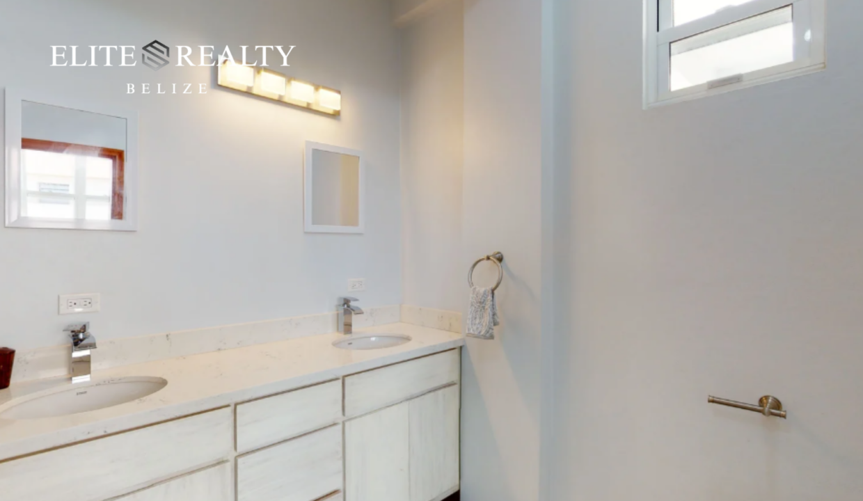Modern Bathroom Vanity With Double Sink And Bright Lighting In Ambergris Caye Belize