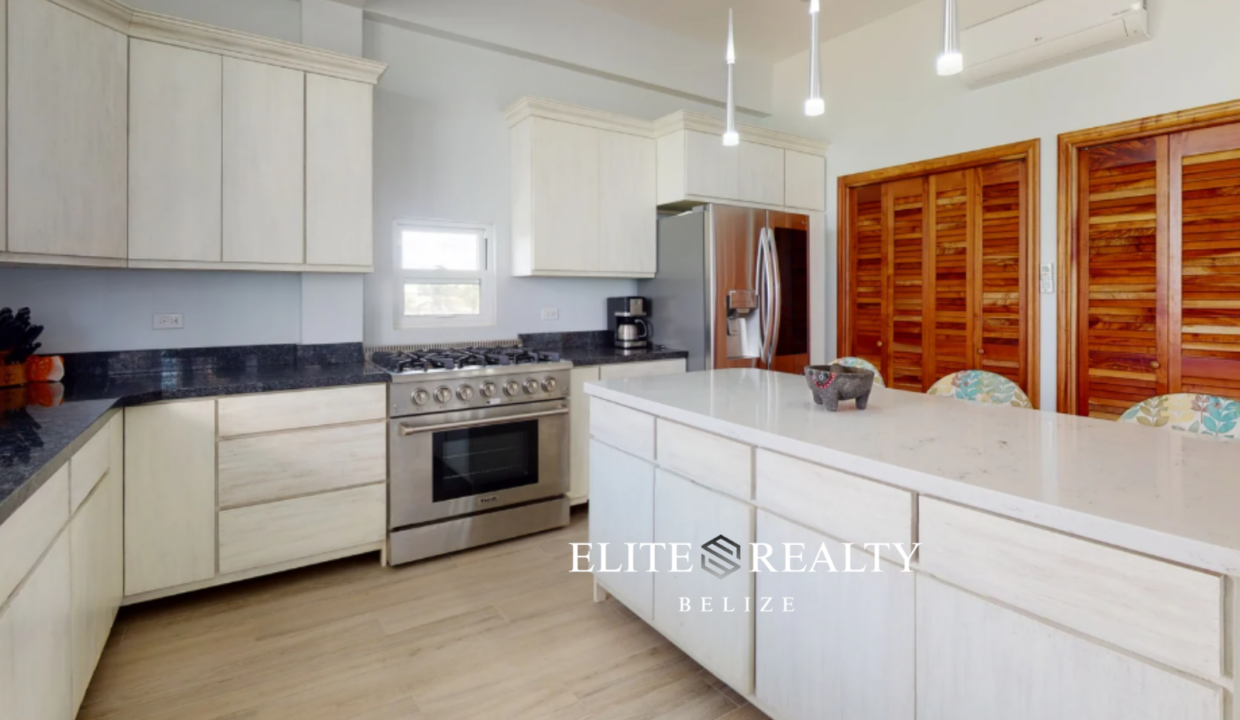Modern Kitchen With Island And Stainless Steel Appliances In Ambergris Caye Belize